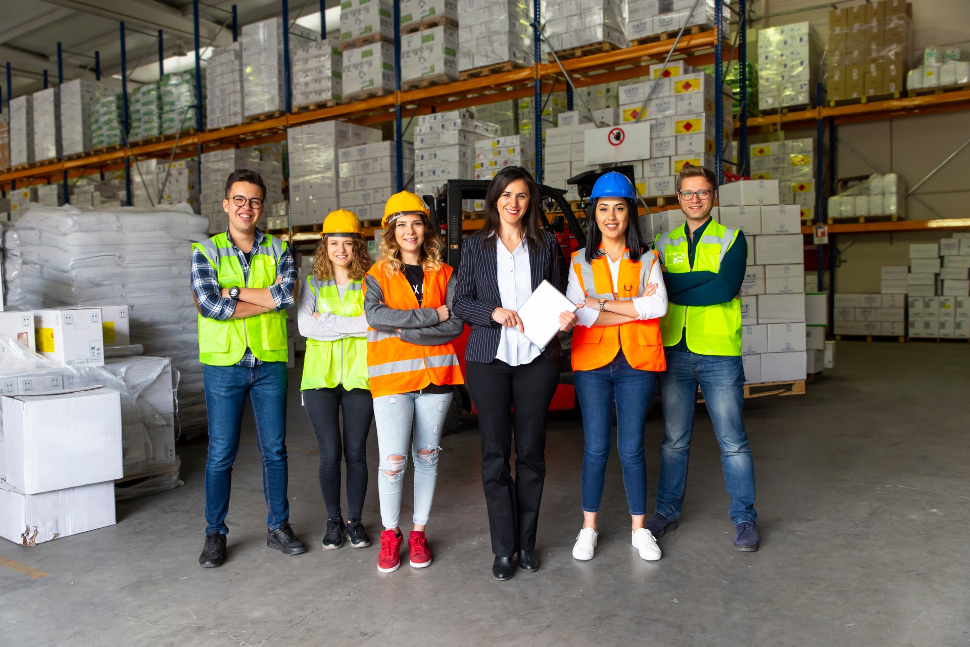 Business colleagues working with computer in warehouse