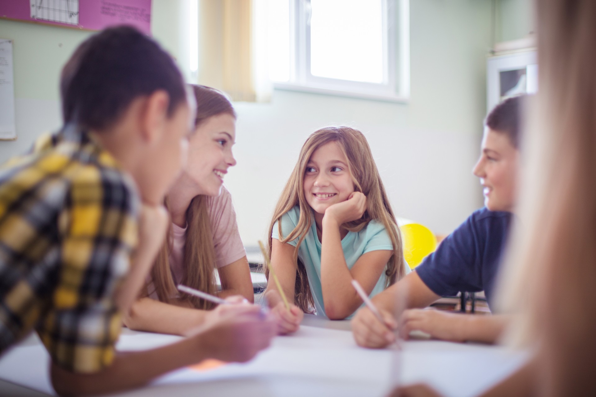 Teenagers students sitting in the classroom and talking.